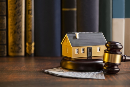 gavel, house model, and money
