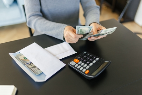 person calculating their budget