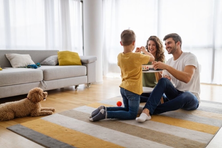 Happy young family having fun together at home.